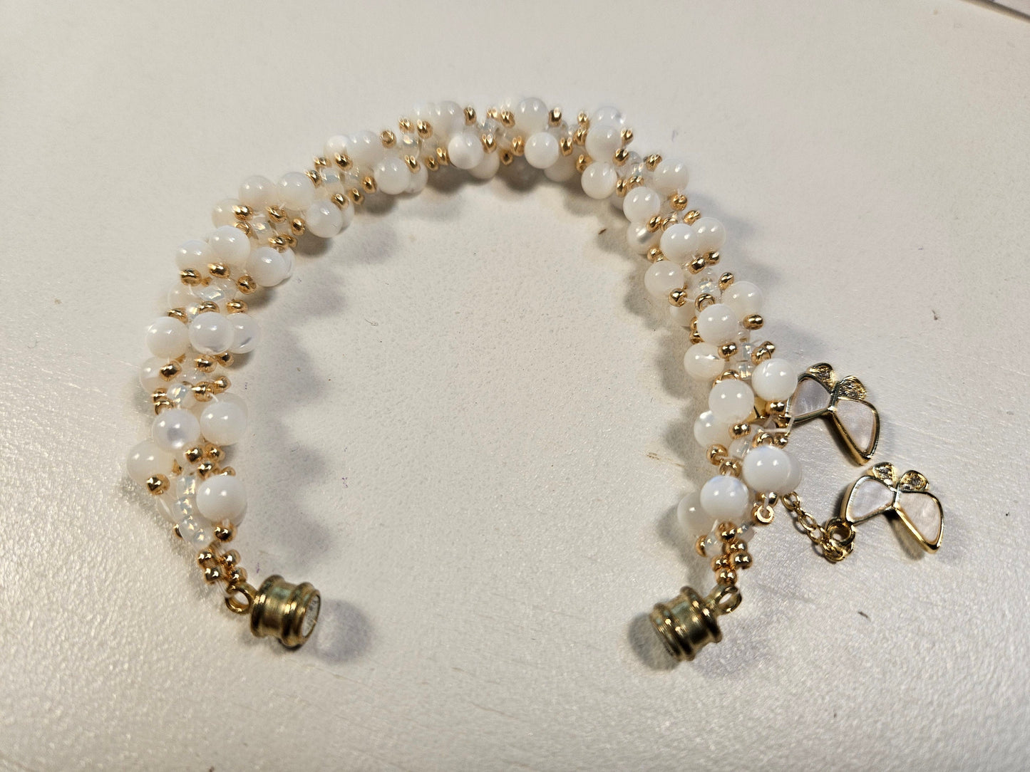 White shell woven spiral bracet- gold accents-magnetic clasp - 7 inch - butterfly charm - beautiful gift