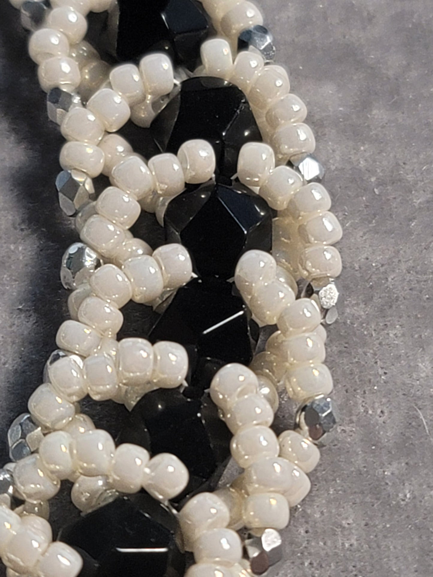 Adjustable bead woven black onyx bracelet with pearlescent beads - silver tone.