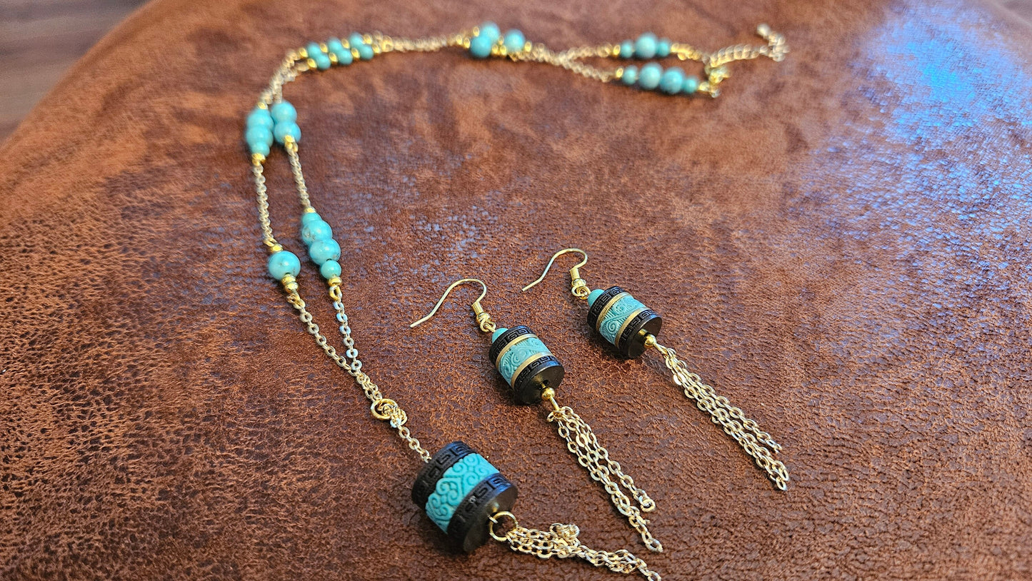 Turquoise necklace and earing set, 24 inch, gold tone chain with tassle and black barrel charms. One of a kind, handmade.