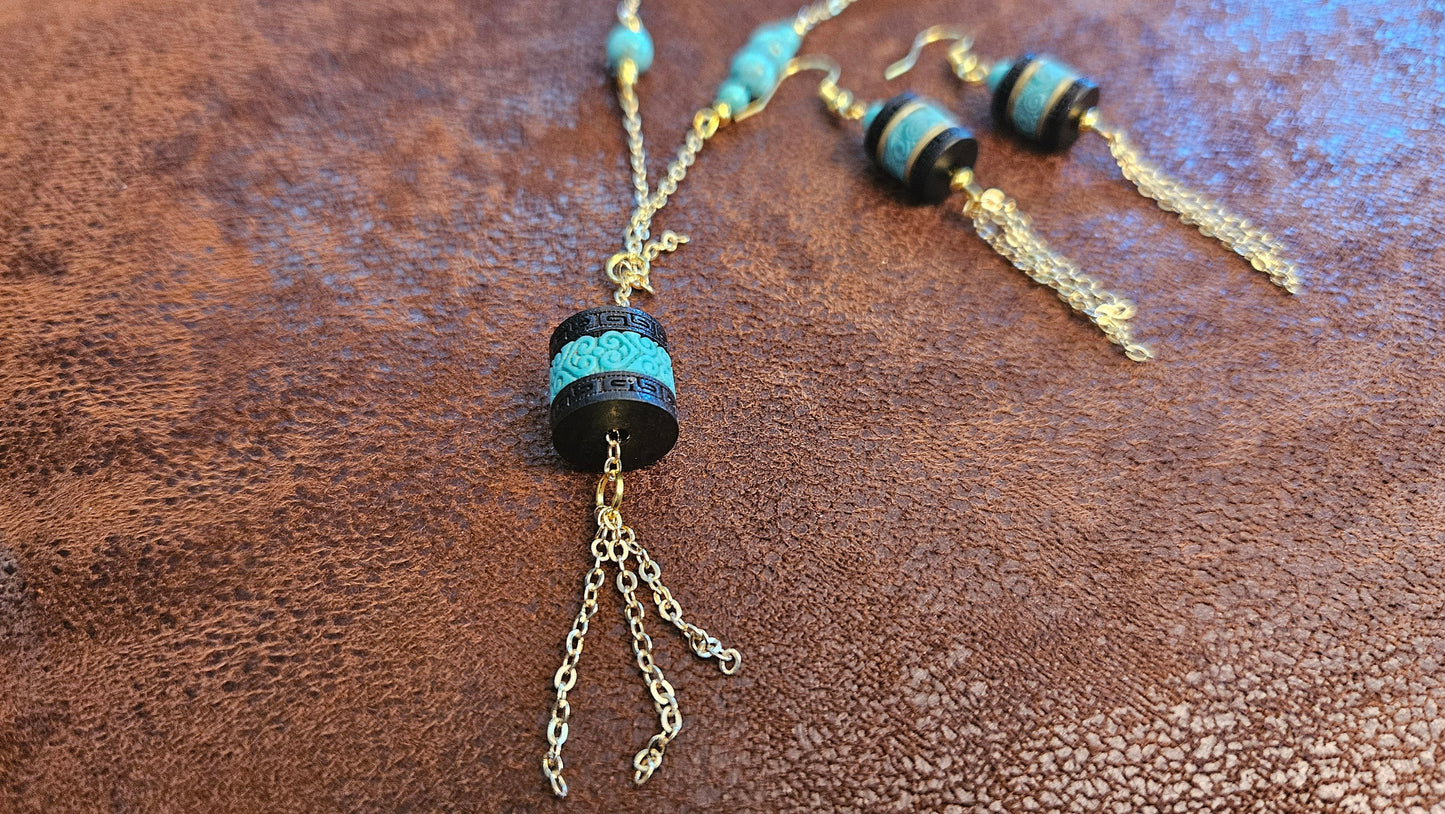 Turquoise necklace and earing set, 24 inch, gold tone chain with tassle and black barrel charms. One of a kind, handmade.