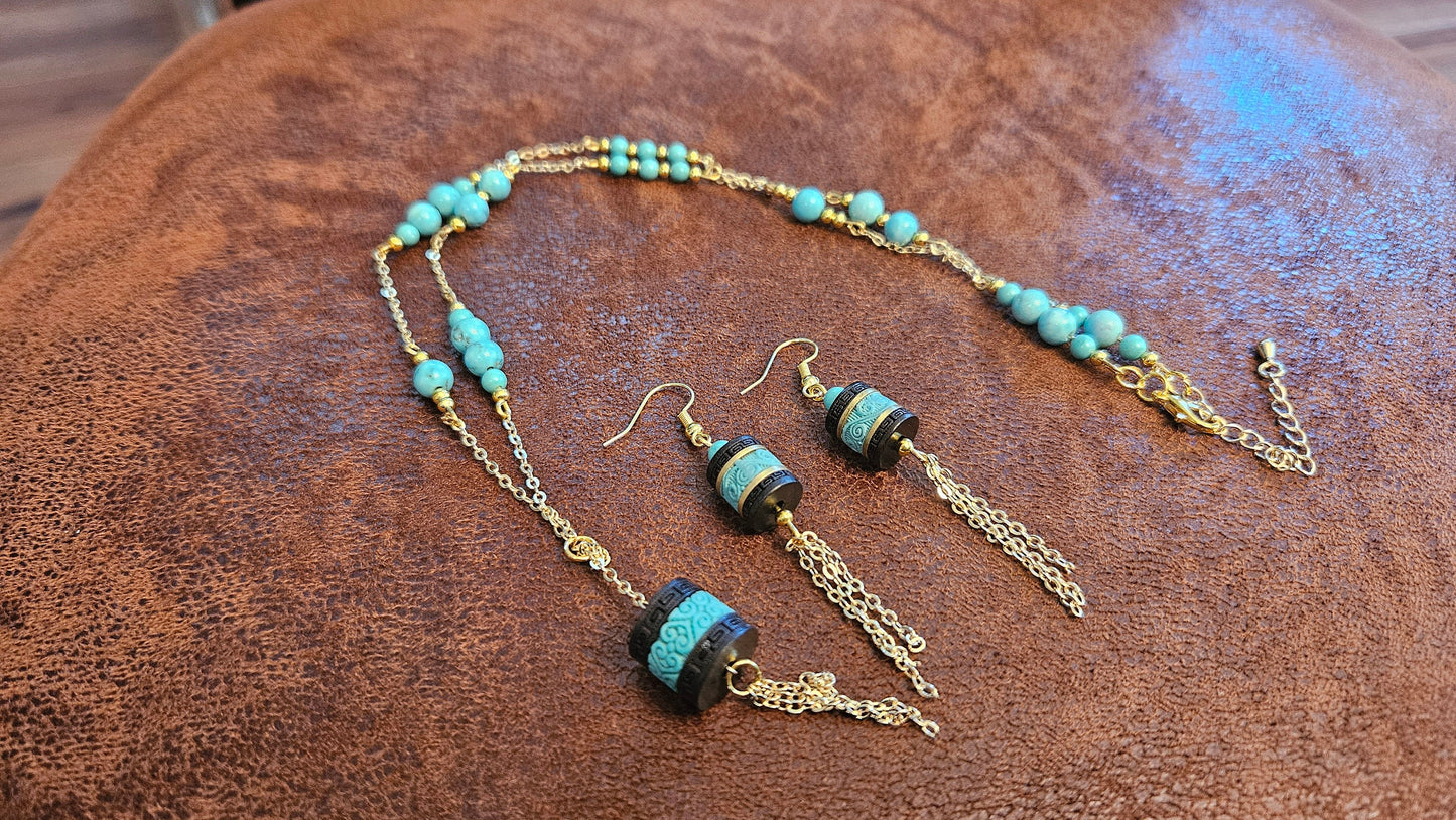 Turquoise necklace and earing set, 24 inch, gold tone chain with tassle and black barrel charms. One of a kind, handmade.